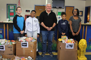 LES students standing with "souper bowl" canned food drive items