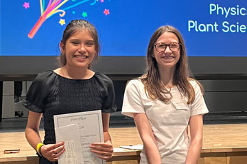 Two students at science fair awards ceremony 