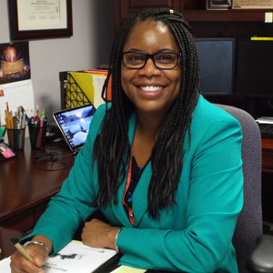 Dr. Crystal Edwards seated at desk