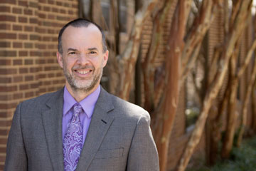 Dr. Jay McClain standing outside the School Administration Building