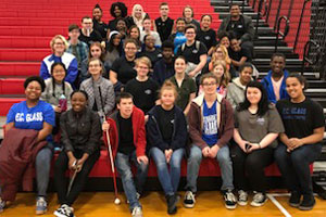ECG chorus students sitting on bleachers at competition