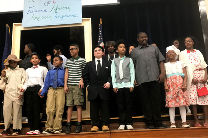 DESI students on stage dressed as famous African-American Virginians