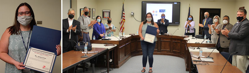 Masked woman holding certificate in front on School Board