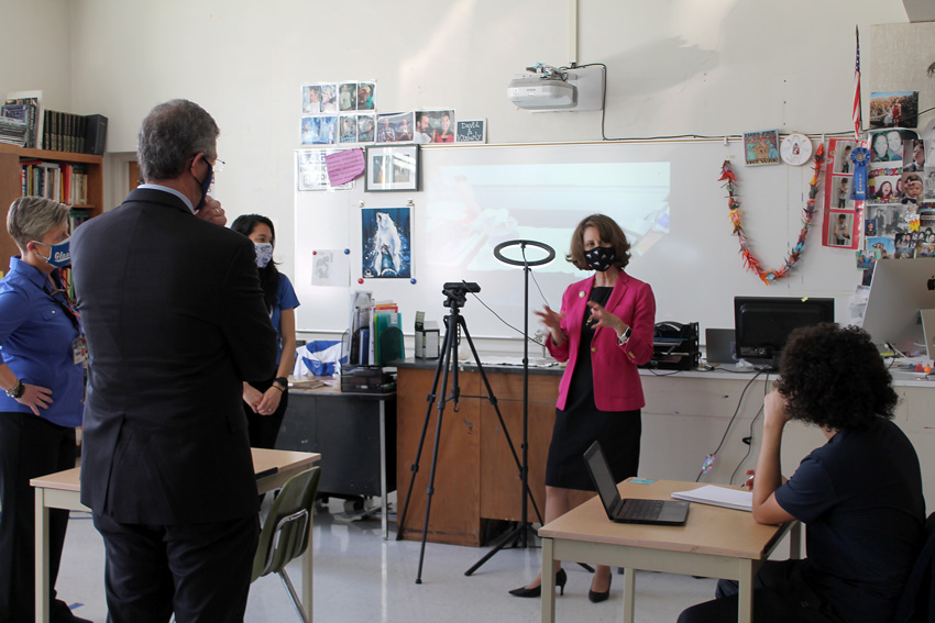 First Lady of Virginia in high school classroom talking with student