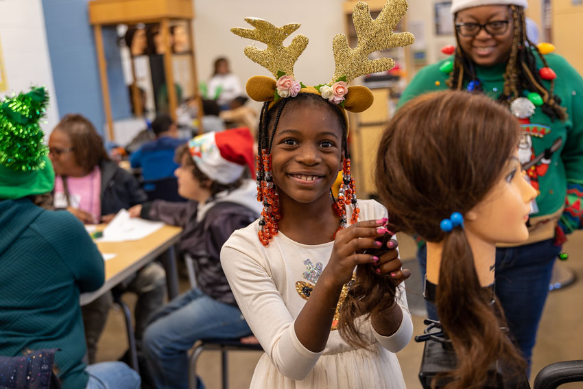 Elementary student with cosmetology mannequin