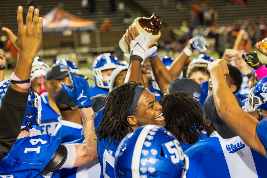 Glass football team celebrating with Little Brown Jug