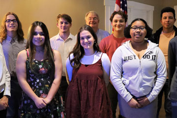 Group of students with Optimist Club members at recognition ceremony