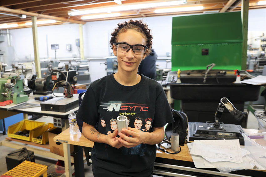 Kori Randolph holding metal machining project