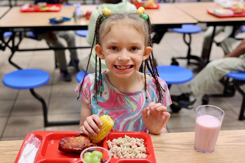 Smiling student at lunch table
