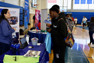 Students talking to representative at career fair