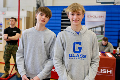 Two students smiling in front of career fair display