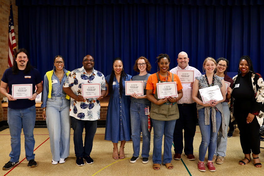 HES and HHS arts teachers holding donation certificates