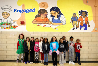 HES students in front of school mural