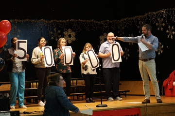 Parent volunteer on stage during read-a-thon event