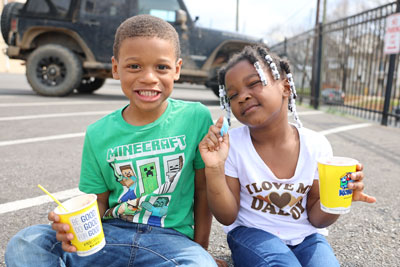 Two students eating ice treats outside