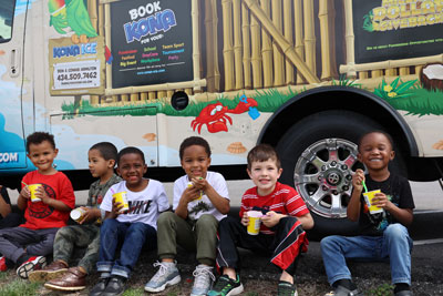 Student enjoying ice treats in front of food truck