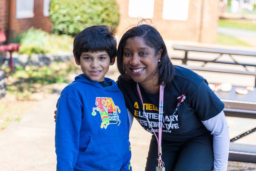 School administrator outside with elementary student