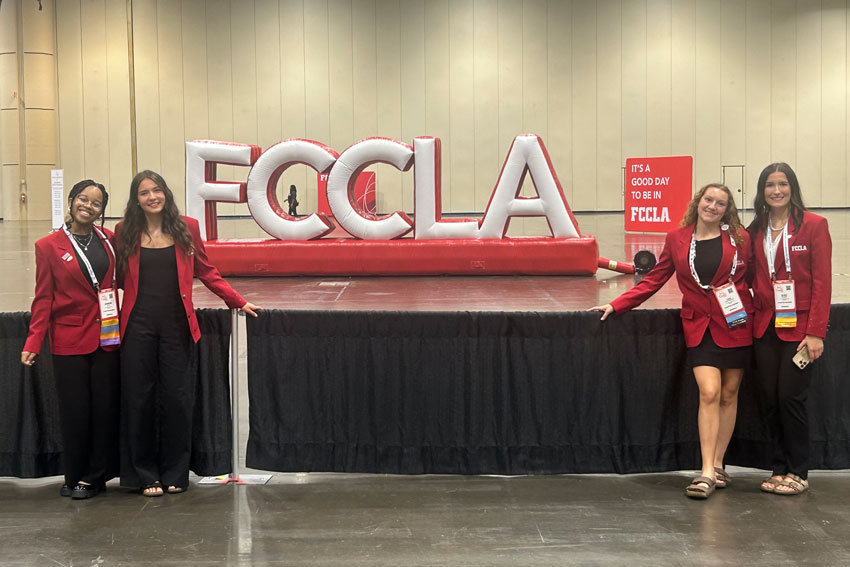 4 students in front of large FCCLA letters