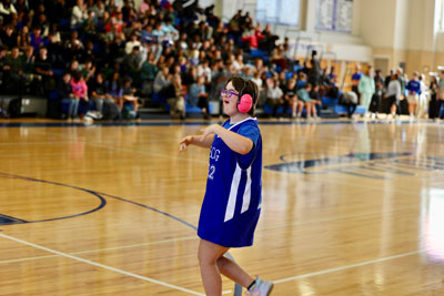 Basketball player in earmuffs on basketball court during game
