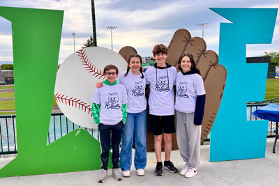 Students wearing matching Hillcat tshirts at the baseball stadium