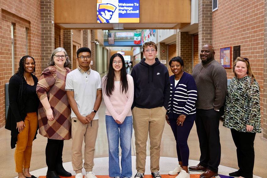 Three high school students with school counseling staff and principal