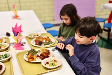 Students at table eating meal
