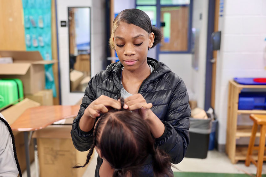 Student braiding hair