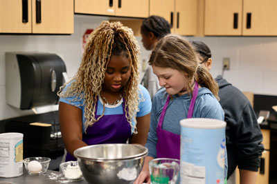 Two middle school students preparing food