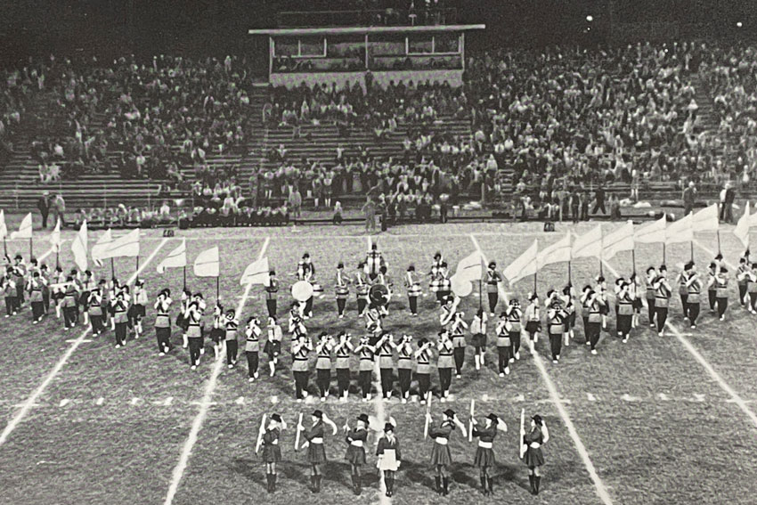 Black and white photo of marching band on football field