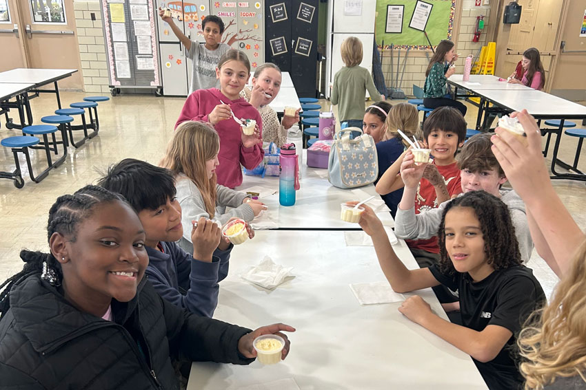 Group of students eating ice cream in school cafeteria