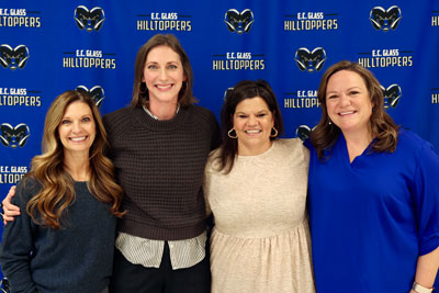 Teacher of the Year standing with three building administrators