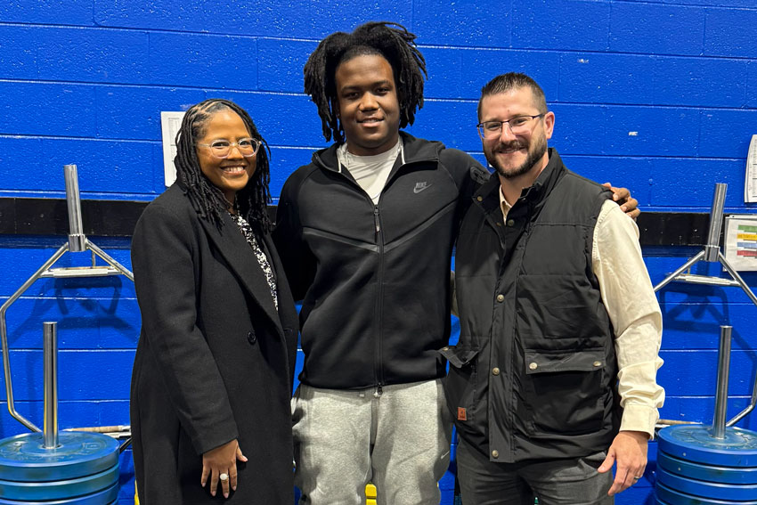 Two school administrators with a high school student