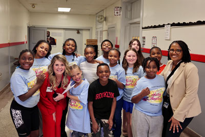 Group of students with principal and Superintendent in school hallway
