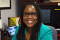 Dr. Crystal Edwards sitting at desk