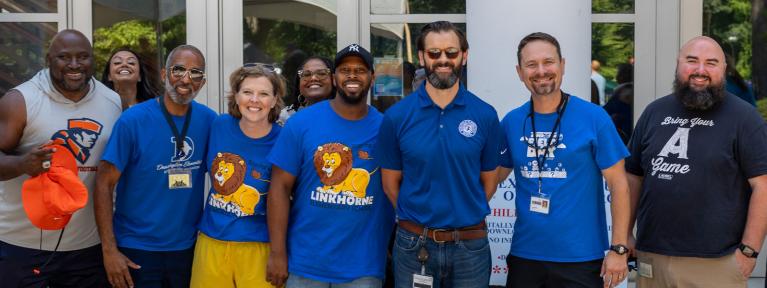 School employees smiling outside