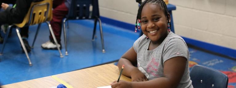 Girl at desk smiling