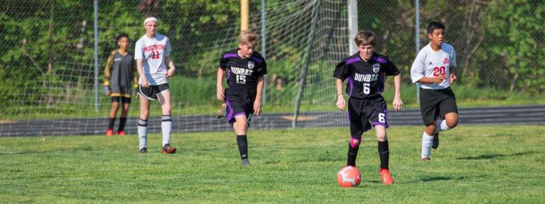 Boys on field playing soccer