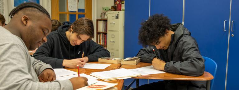 Students in classroom writing at desks