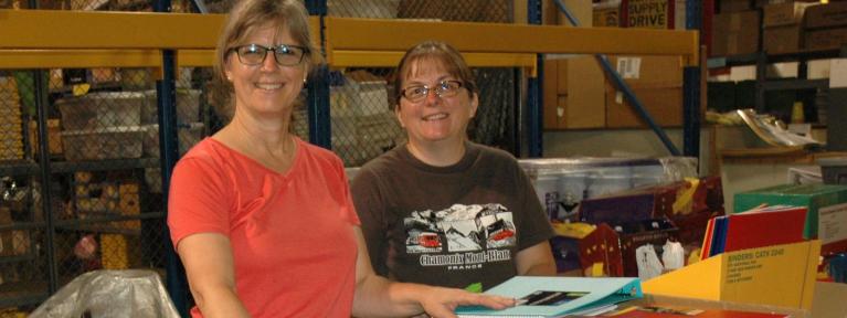 Volunteers in warehouse with school supplies