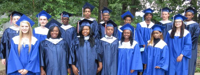 Group of graduates outside in cap and gowns