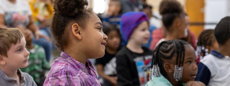 Pre-K students sitting on floor during assembly