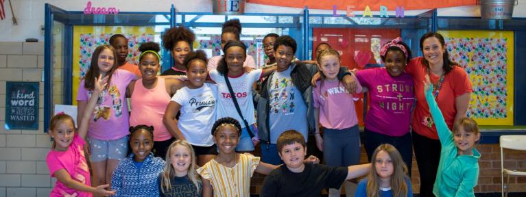 Students smiling in school hallway