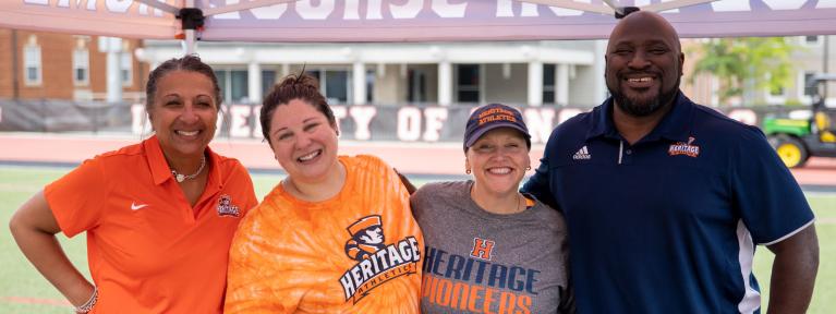 School administrators wearing Heritage apparel at a community event 