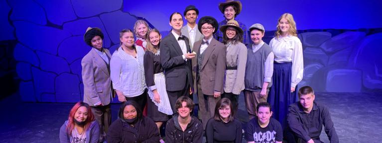 Actors and crew on stage