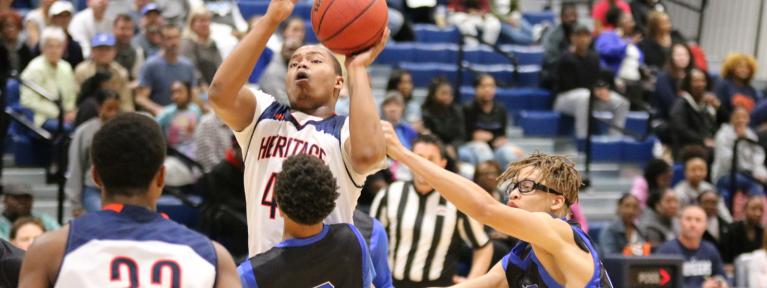 Boy shooting jump shot over defender