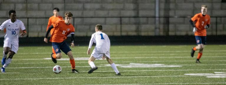 Soccer player surrounded by defenders