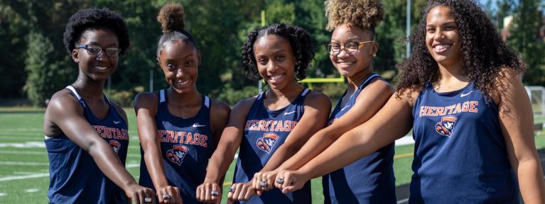 Girls track team members showing championship ring