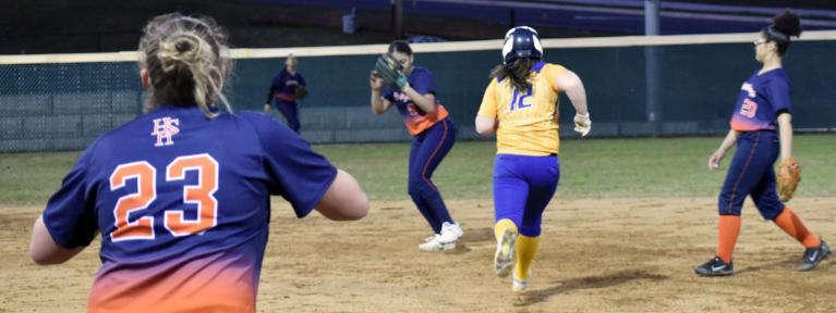 Softball infielder stepping on base