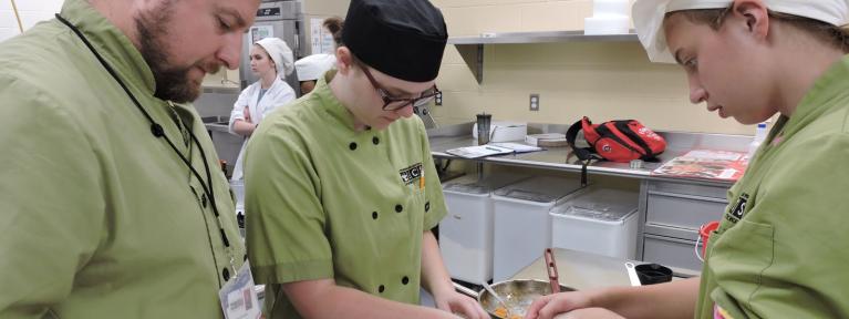 Culinary arts students with teacher