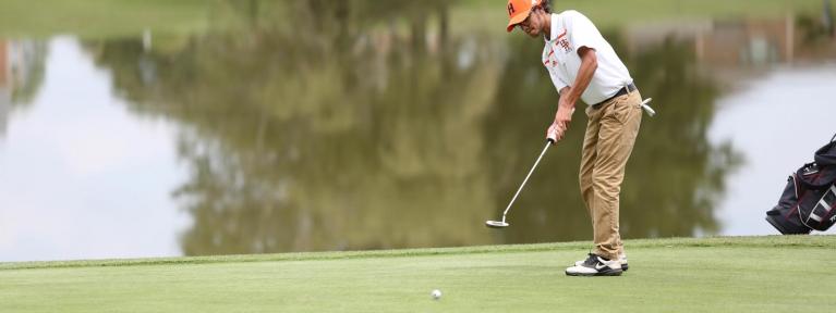 Golfer putting on green